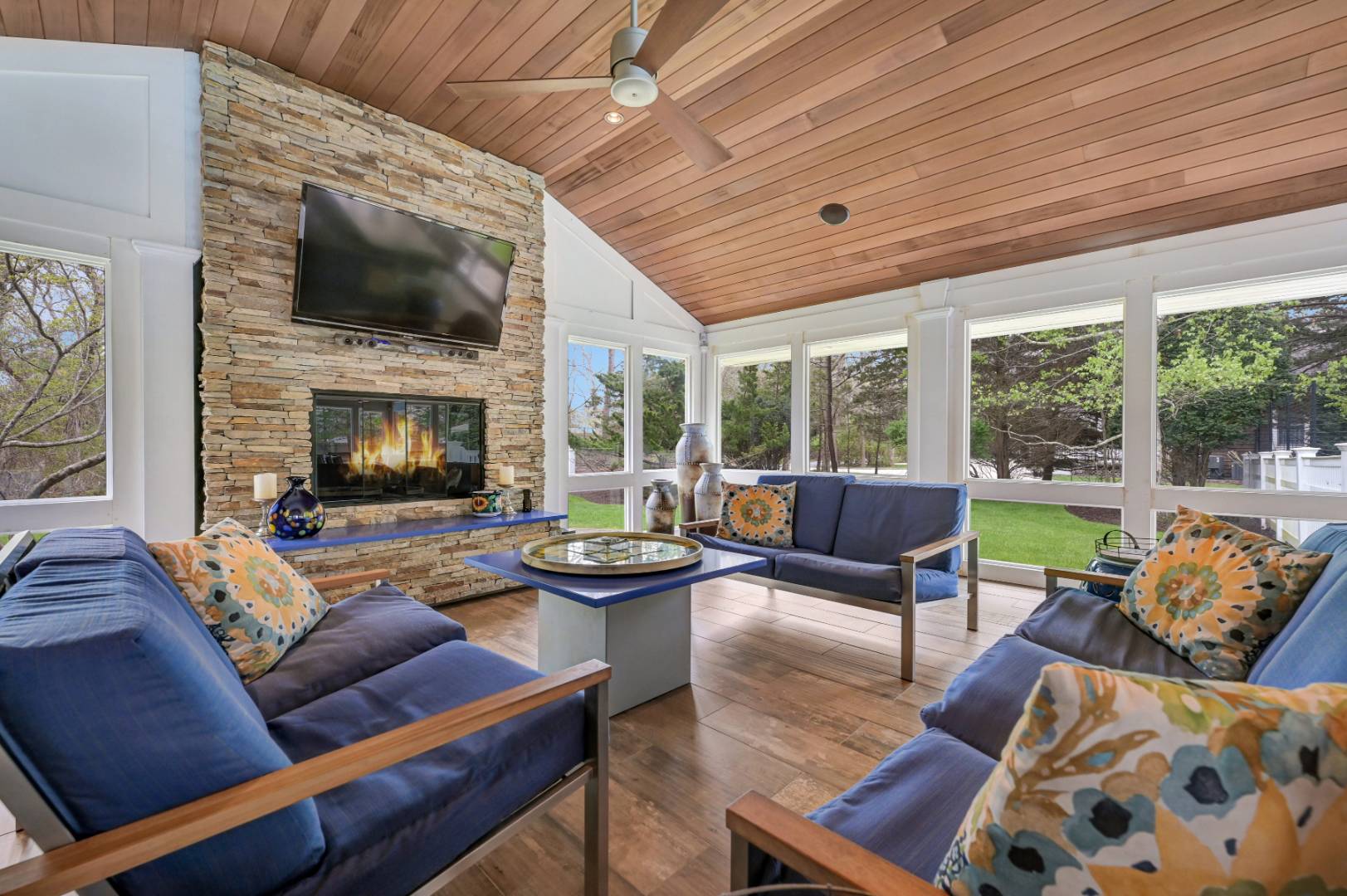60 South Road Westhampton Beach, NY 11978 - Photo 26 of 45 a living room with furniture a fireplace and a flat screen tv