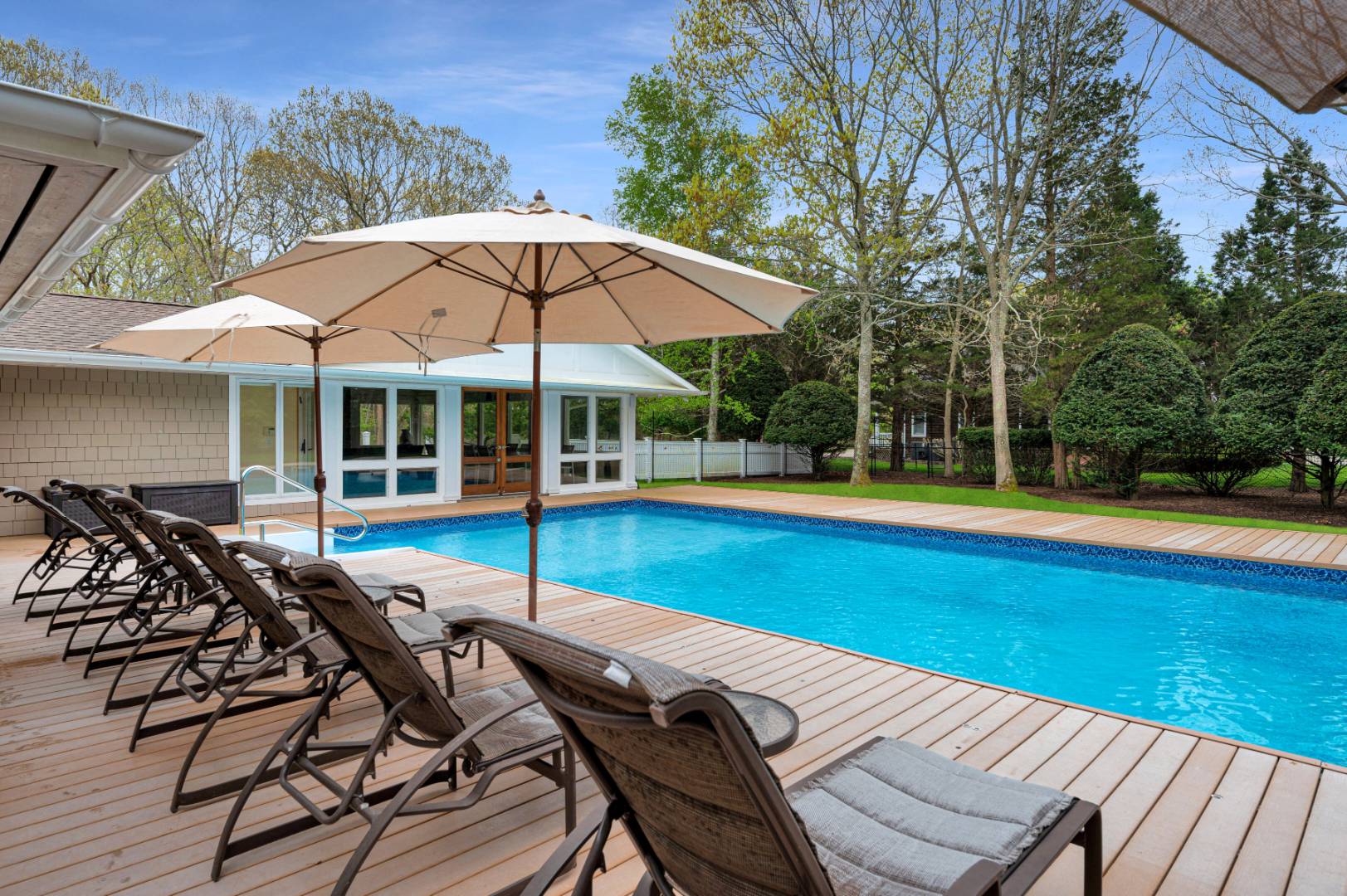 60 South Road Westhampton Beach, NY 11978 - Photo 28 of 45 a view of a swimming pool with lounge chairs