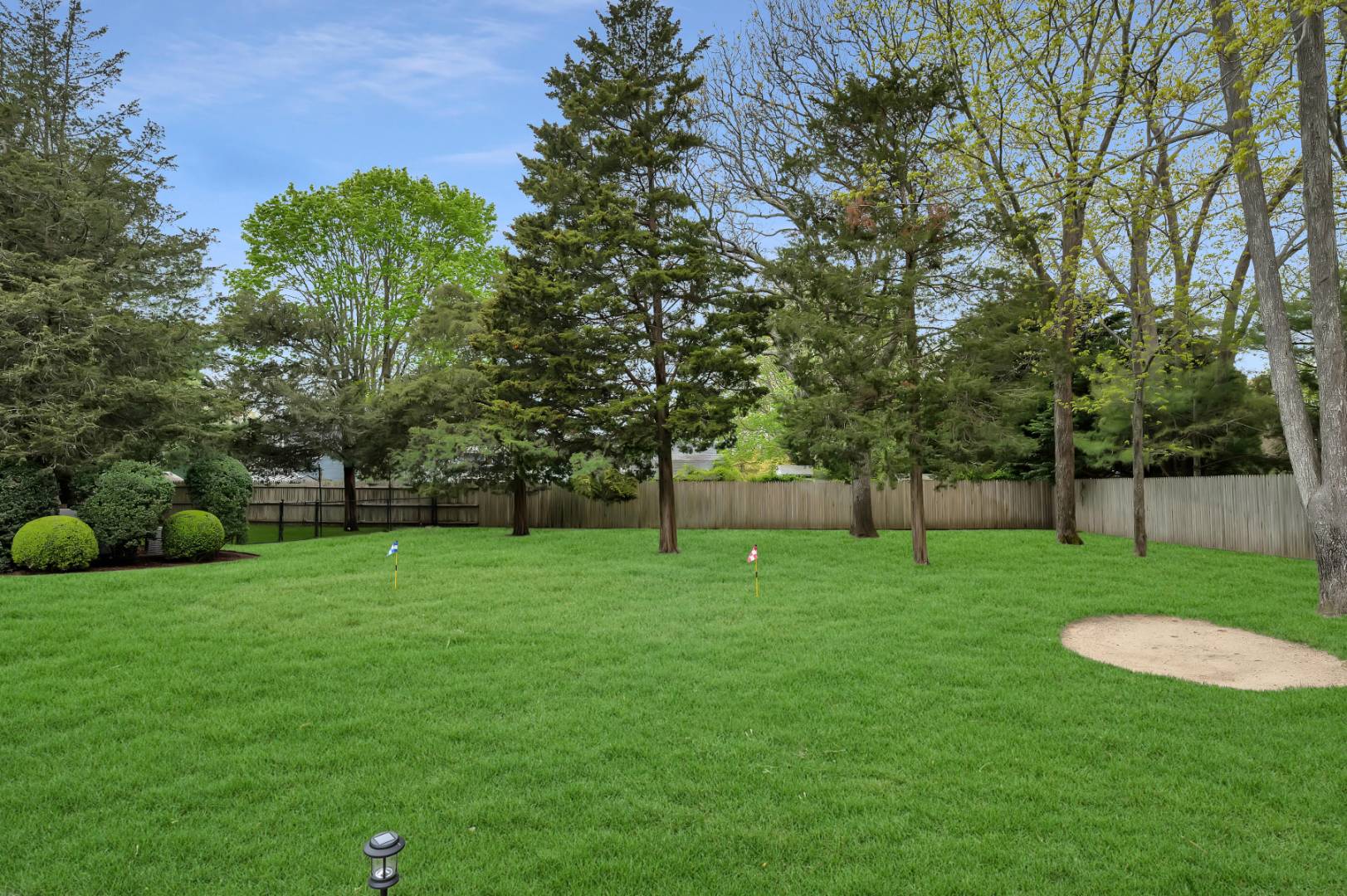 60 South Road Westhampton Beach, NY 11978 - Photo 34 of 45 a view of a grassy field with trees in the background