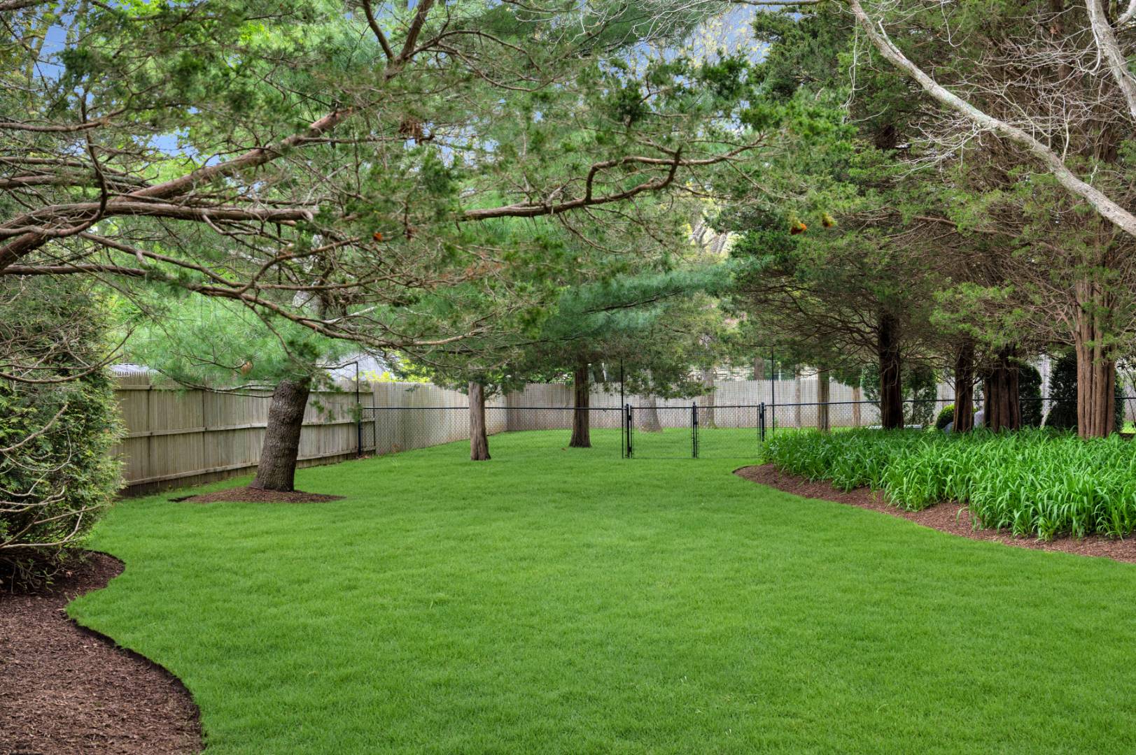 60 South Road Westhampton Beach, NY 11978 - Photo 35 of 45 a view of a backyard with large trees