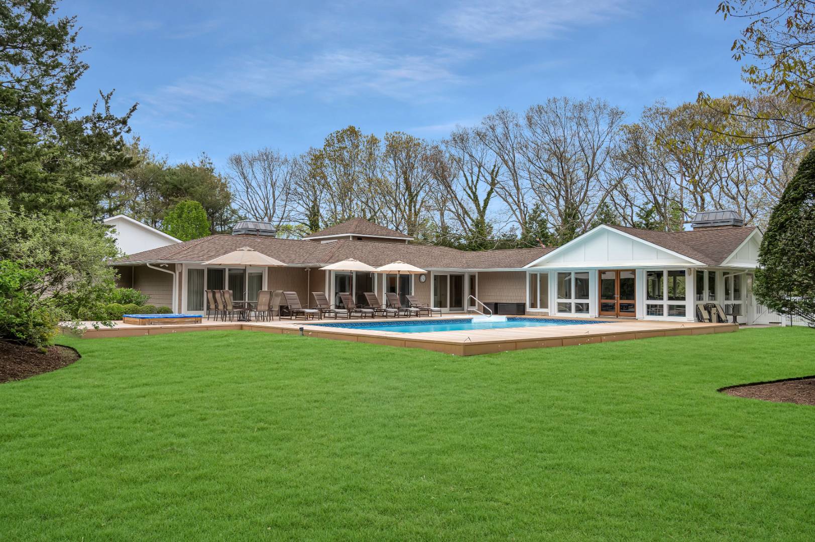 60 South Road Westhampton Beach, NY 11978 - Photo 37 of 45 a front view of a house with swimming pool having outdoor seating