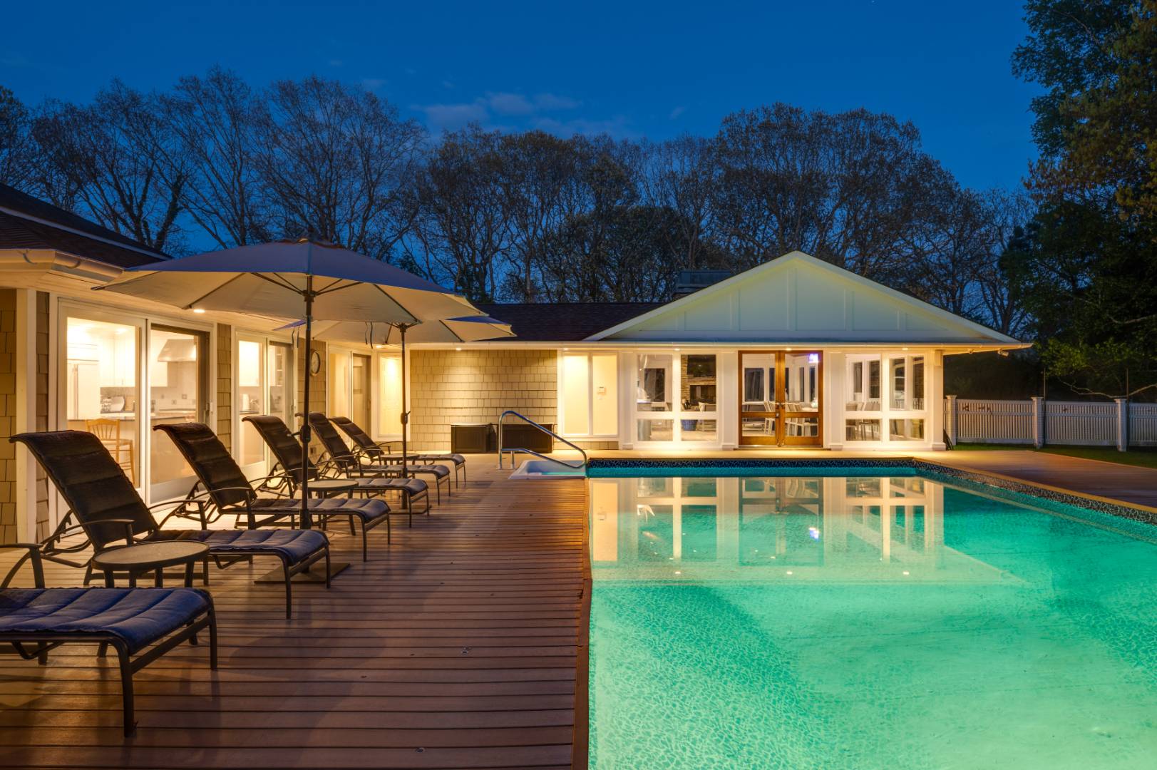 60 South Road Westhampton Beach, NY 11978 - Photo 40 of 45 a view of a swimming pool with lawn chairs under an umbrella