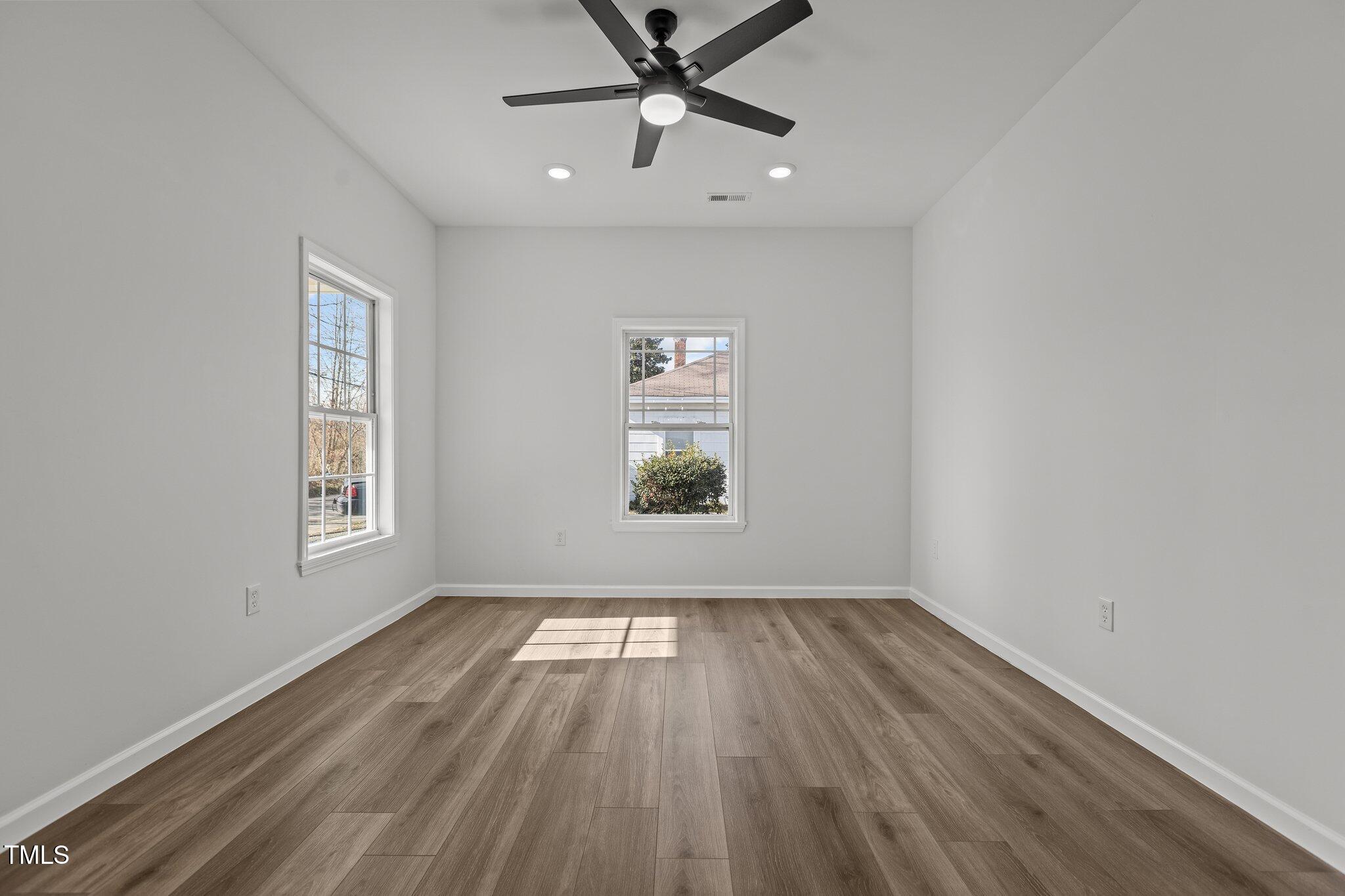 112 Edgewood Drive Roxboro, NC 27573 - Photo 11 of 37 wooden floor in an empty room with a window