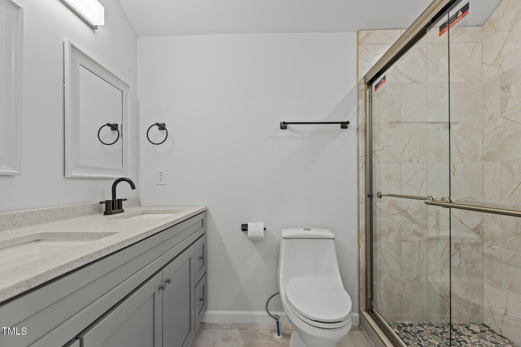 112 Edgewood Drive Roxboro, NC 27573 - Photo 16 of 37 a bathroom with a granite countertop sink toilet and a mirror