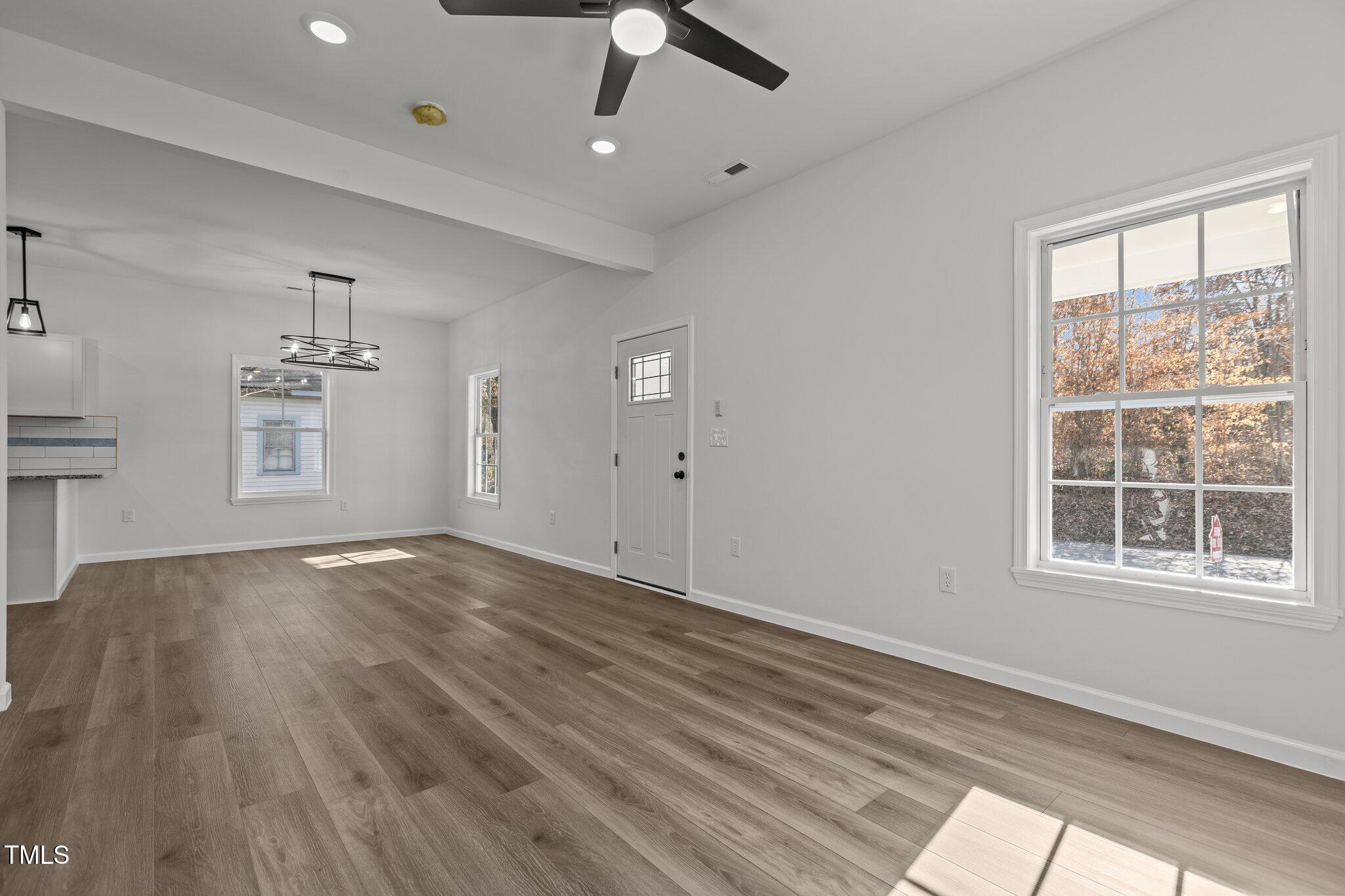 112 Edgewood Drive Roxboro, NC 27573 - Photo 19 of 37 wooden floor in an empty room with a window