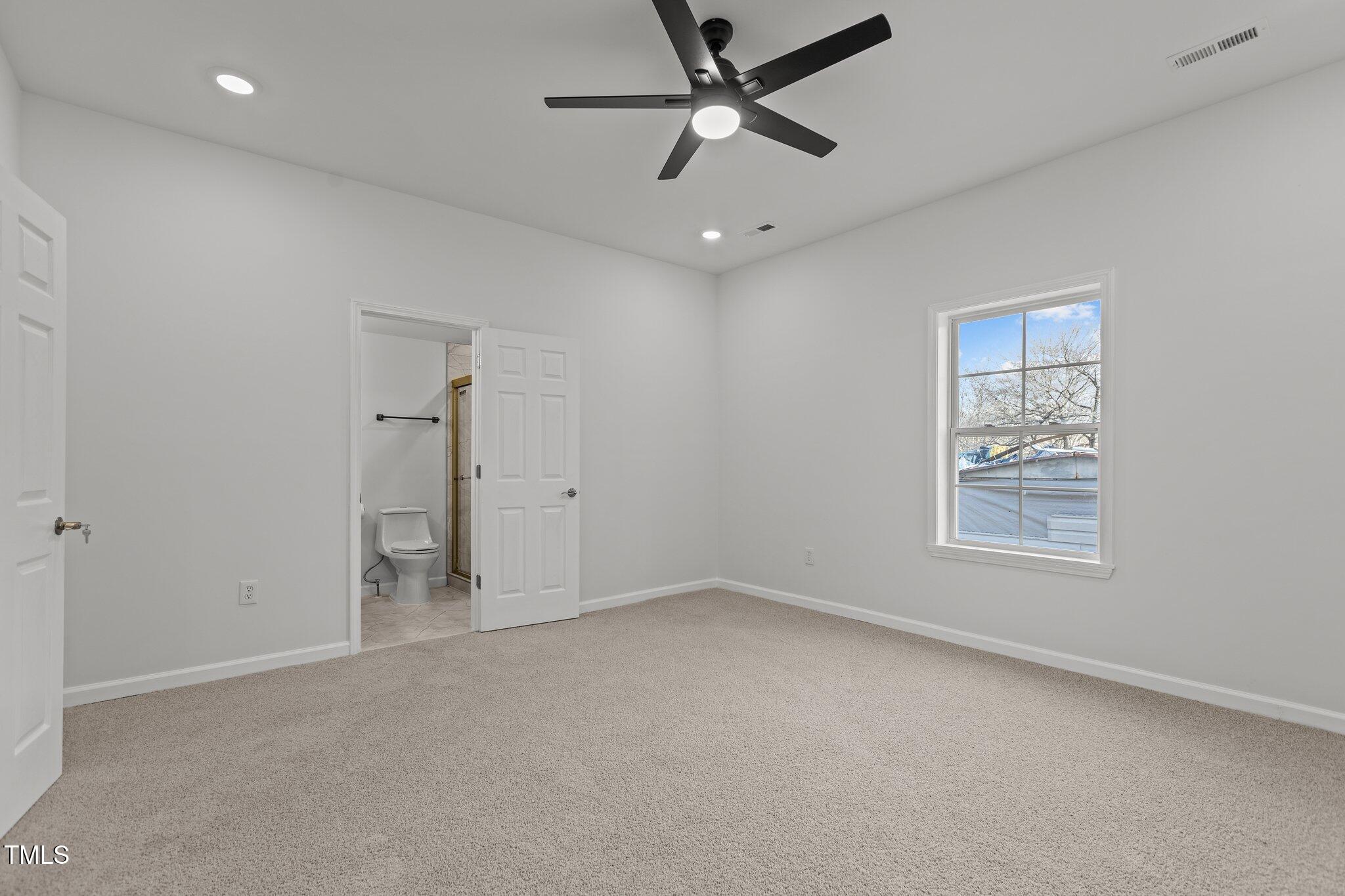 112 Edgewood Drive Roxboro, NC 27573 - Photo 23 of 37 an empty room with a window and a fan