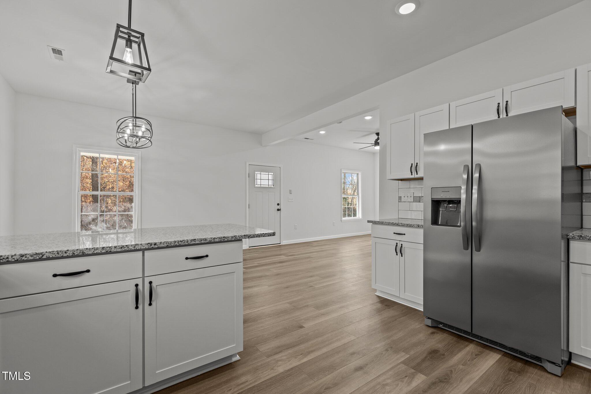 112 Edgewood Drive Roxboro, NC 27573 - Photo 5 of 37 a kitchen with granite countertop a refrigerator and a sink