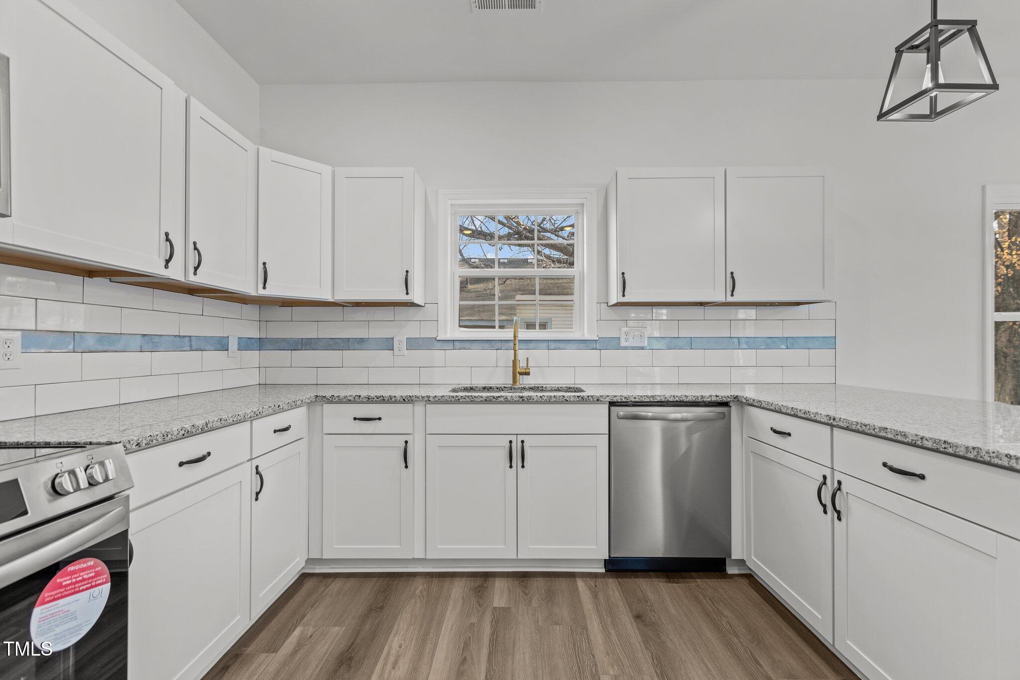 112 Edgewood Drive Roxboro, NC 27573 - Photo 7 of 37 a kitchen with granite countertop cabinets stainless steel appliances and a sink