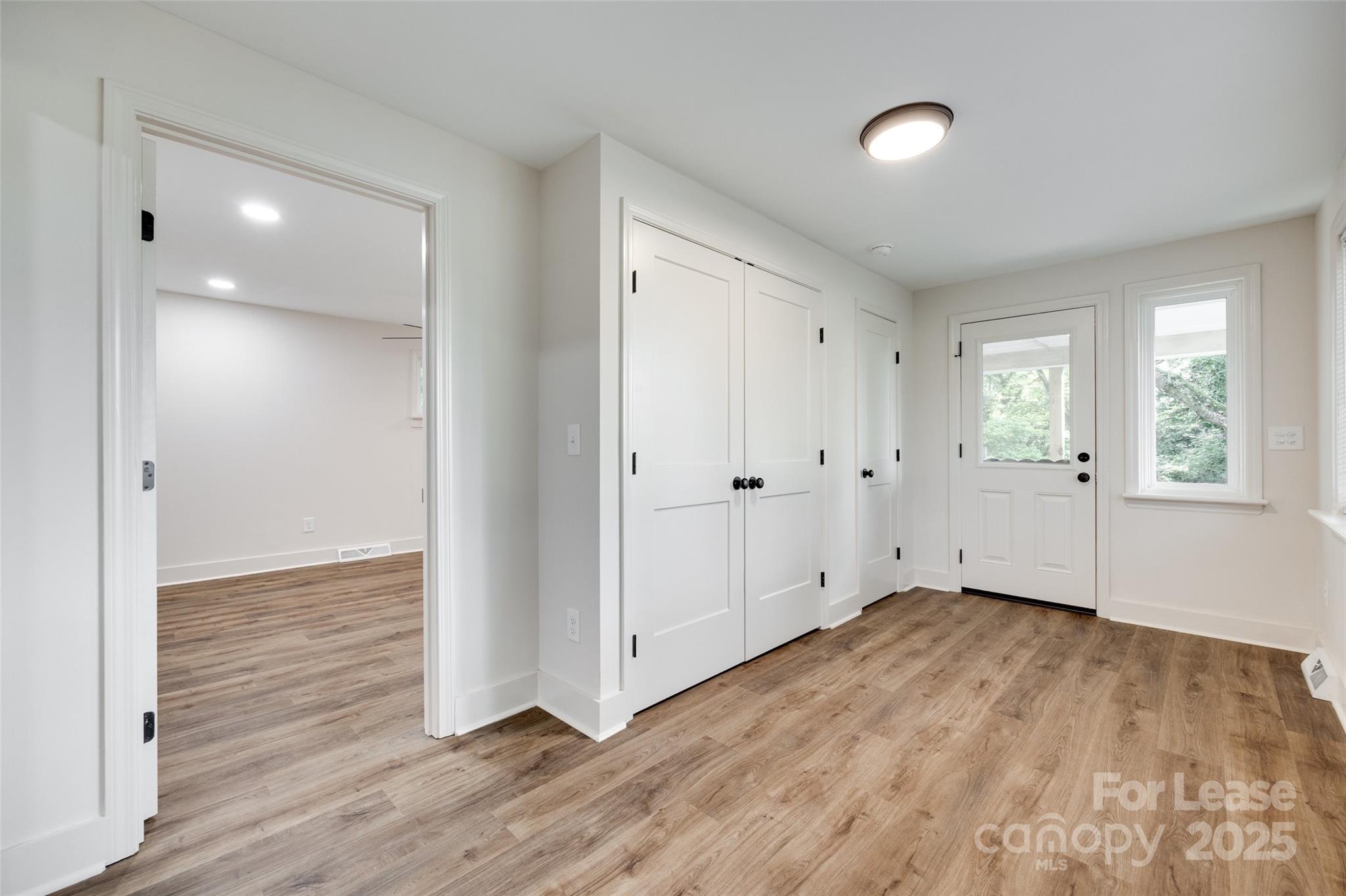 3113 E Highway, Unit 218 Monroe, NC 28110 - Photo 11 of 27 an empty room with wooden floor and windows