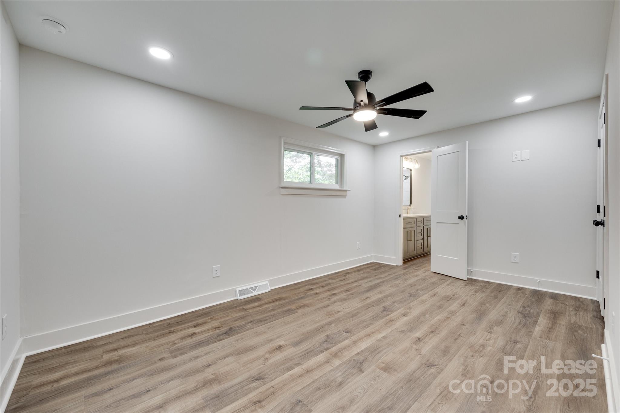 3113 E Highway, Unit 218 Monroe, NC 28110 - Photo 12 of 27 wooden floor in an empty room with a window