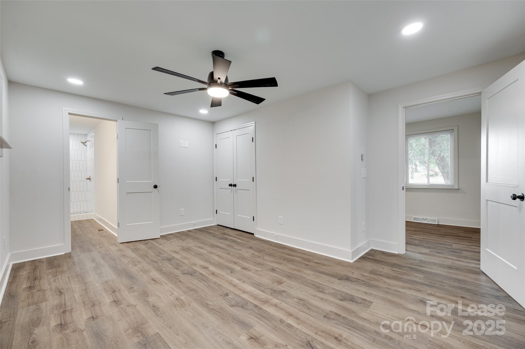 3113 E Highway, Unit 218 Monroe, NC 28110 - Photo 13 of 27 a view of an empty room with wooden floor and a ceiling fan