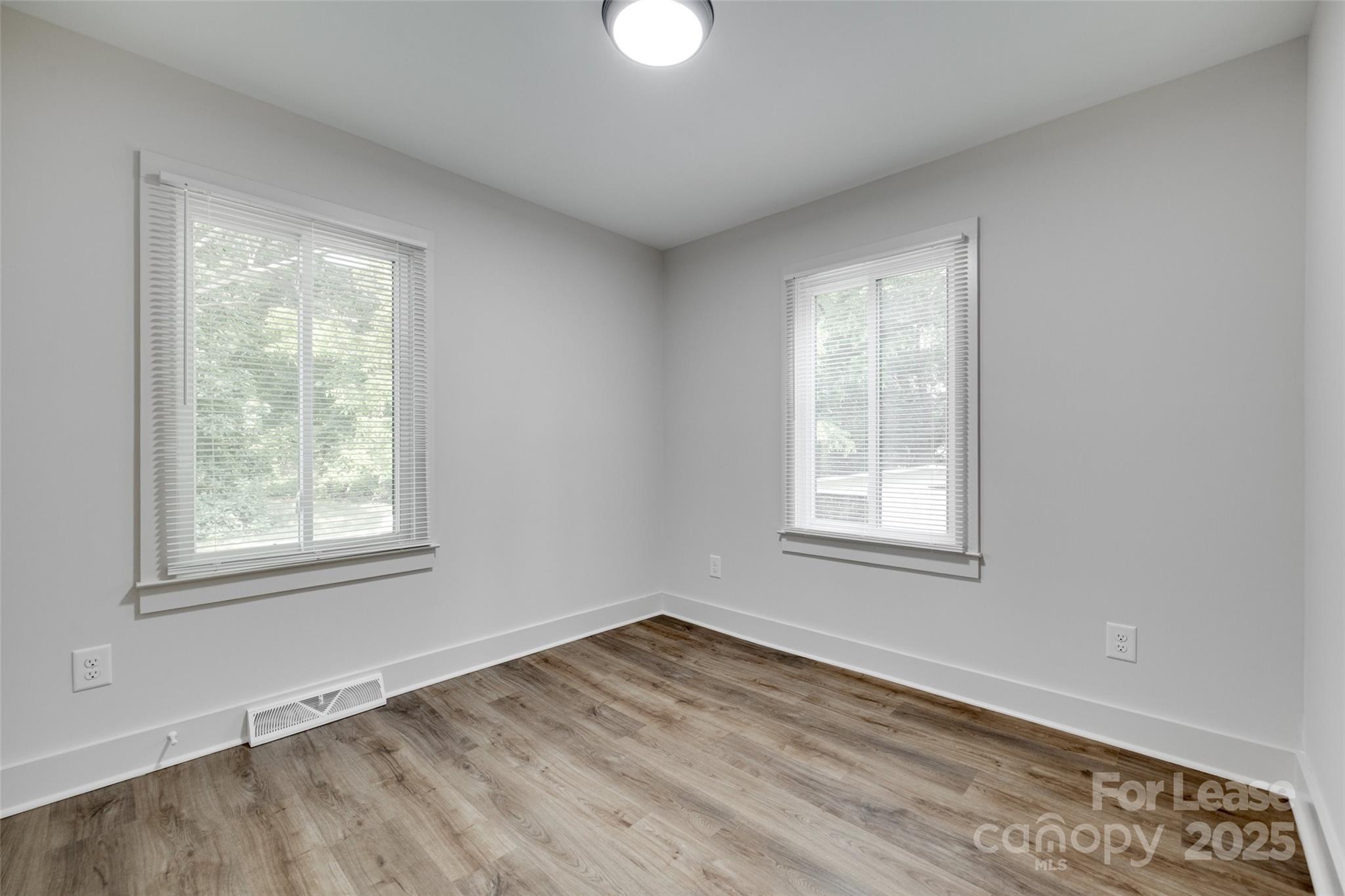 3113 E Highway, Unit 218 Monroe, NC 28110 - Photo 17 of 27 an empty room with wooden floor and windows