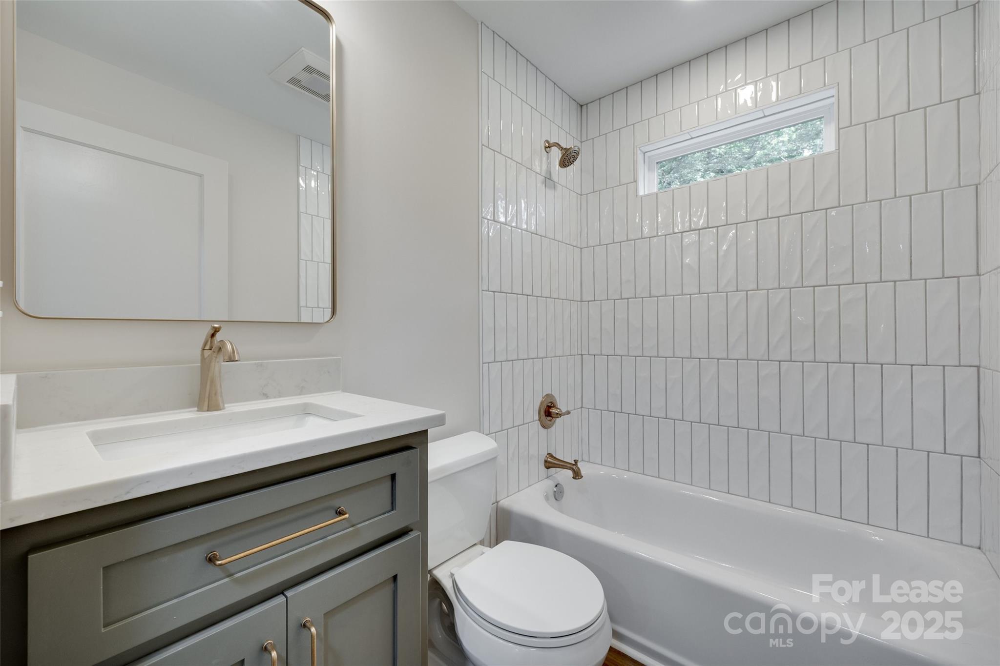 3113 E Highway, Unit 218 Monroe, NC 28110 - Photo 21 of 27 a bathroom with a sink a toilet and bathtub