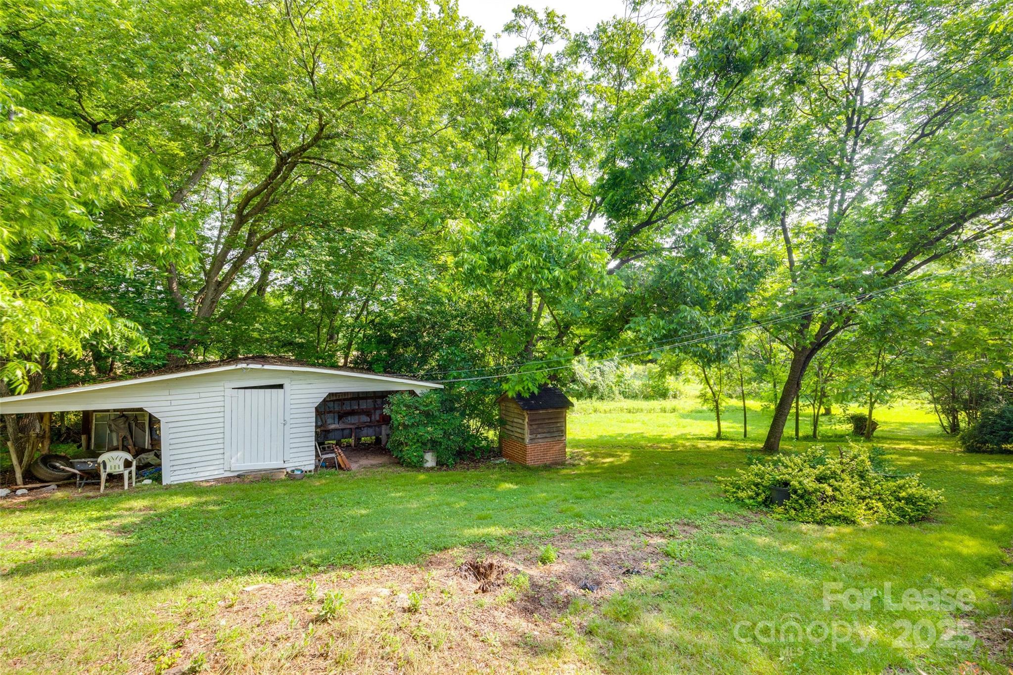 3113 E Highway, Unit 218 Monroe, NC 28110 - Photo 23 of 27 a view of a backyard with large trees