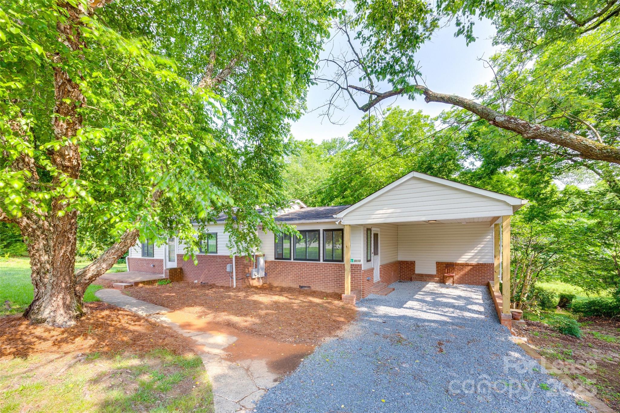 3113 E Highway, Unit 218 Monroe, NC 28110 - Photo 27 of 27 a view of a patio with a table and chairs under an umbrella