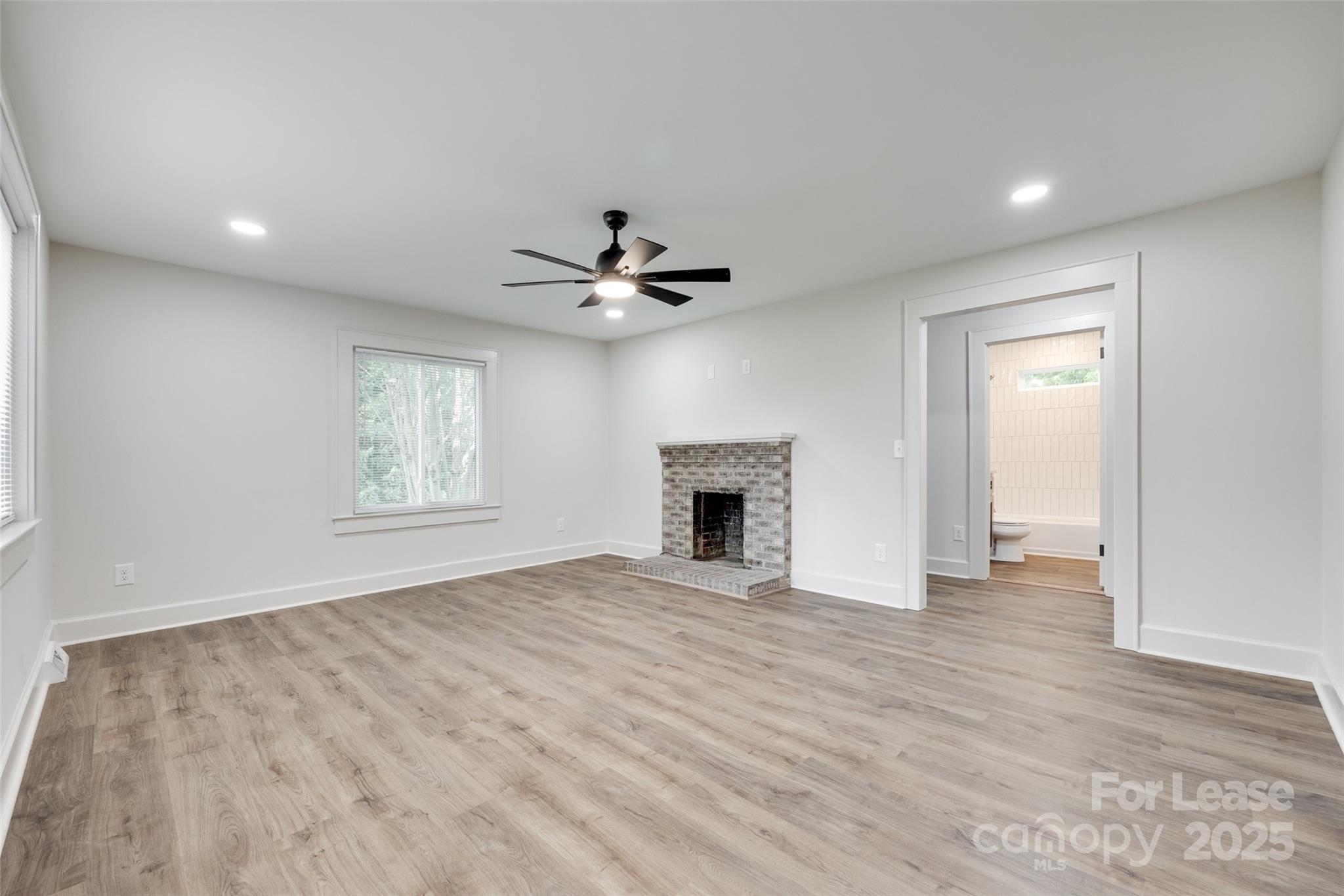 3113 E Highway, Unit 218 Monroe, NC 28110 - Photo 4 of 27 a view of an empty room with a window and a kitchen