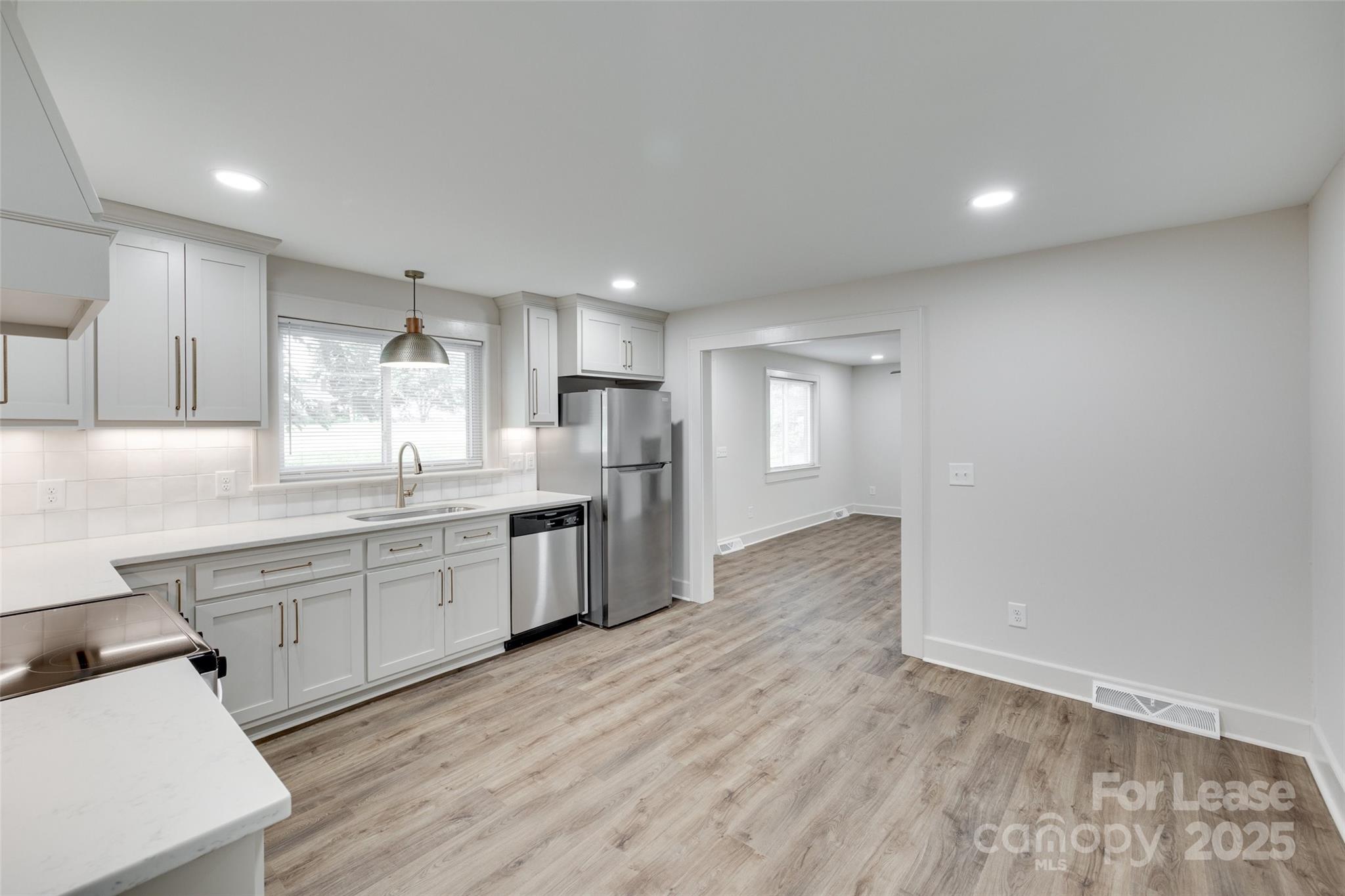 3113 E Highway, Unit 218 Monroe, NC 28110 - Photo 7 of 27 a large kitchen with granite countertop a large counter top appliances and cabinets