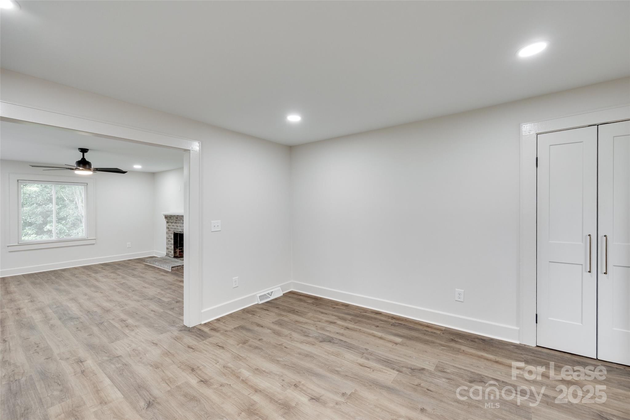 3113 E Highway, Unit 218 Monroe, NC 28110 - Photo 10 of 27 an empty room with wooden floor cabinet and windows