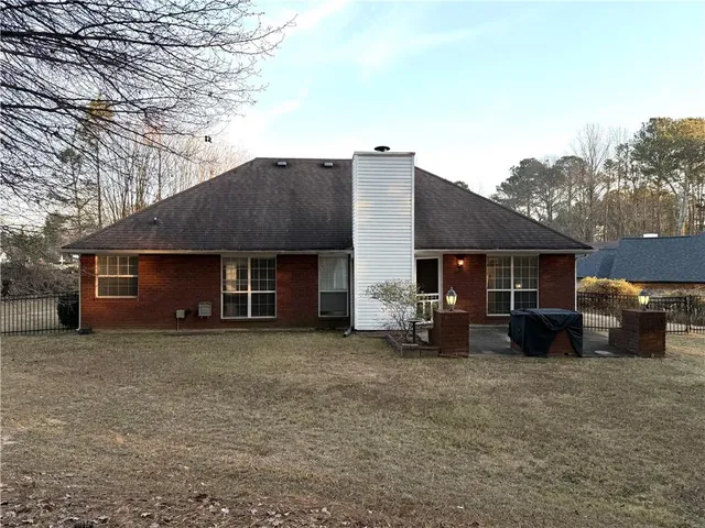 a view of a house with a yard and a car parked in front of it