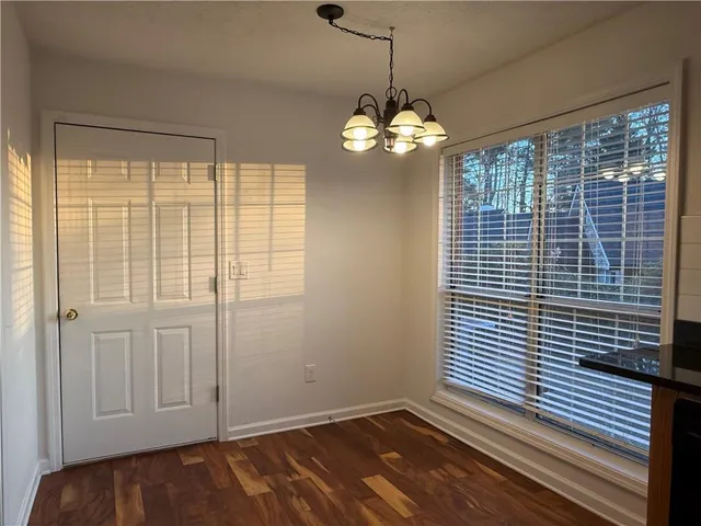 a view of a livingroom with a chandelier furniture and windows