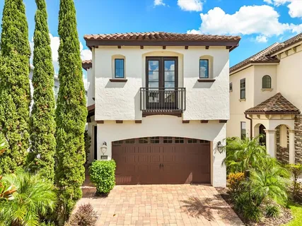 a view of a white house next to a yard