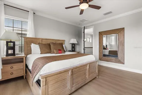 a bedroom with a bed and a chandelier