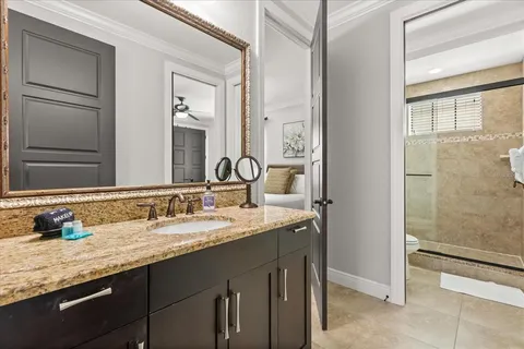 a bathroom with a granite countertop sink and a mirror