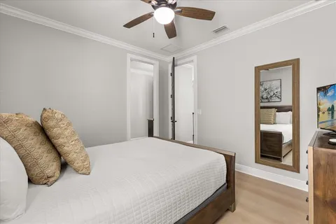 a bedroom with a large bed and a chandelier