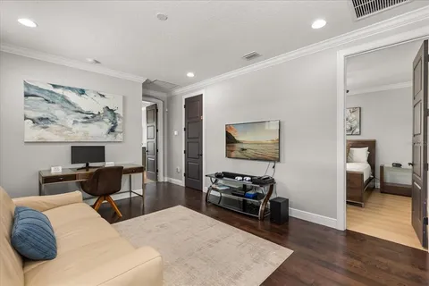 a bedroom with furniture and a painting on the wall