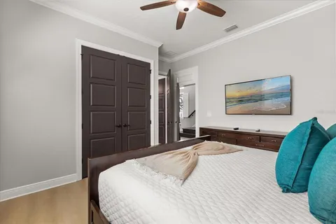 a bedroom with a bed and a flat screen tv