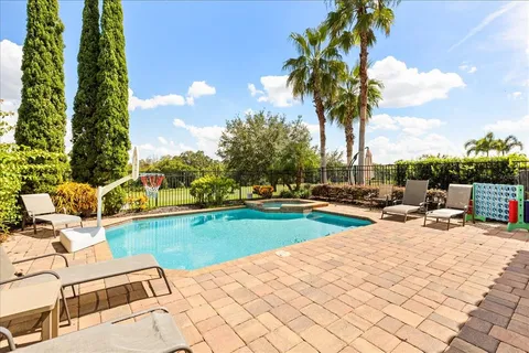 a view of a swimming pool with a garden and trees