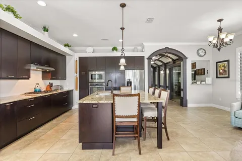 a large kitchen with a table and chairs