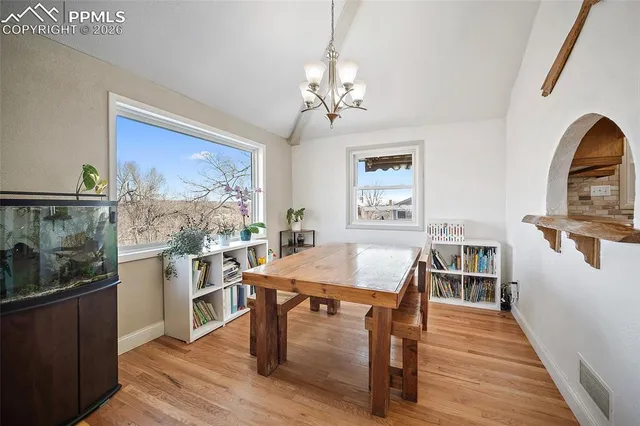 a view of a dining room with furniture window and wooden floor