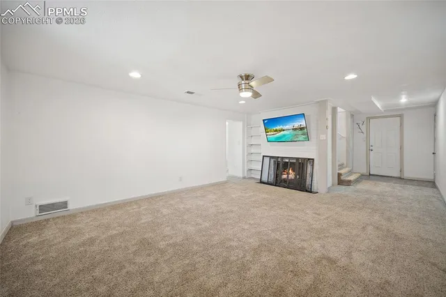 a view of an empty room with a fireplace