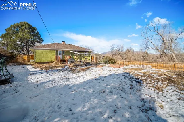 a view of a patio with a table and chairs