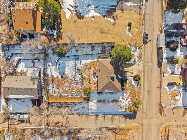 an aerial view of residential houses with yard
