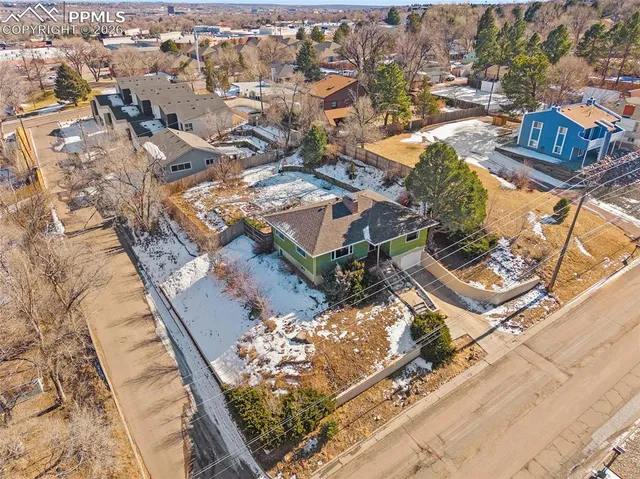 an aerial view of residential houses with outdoor space