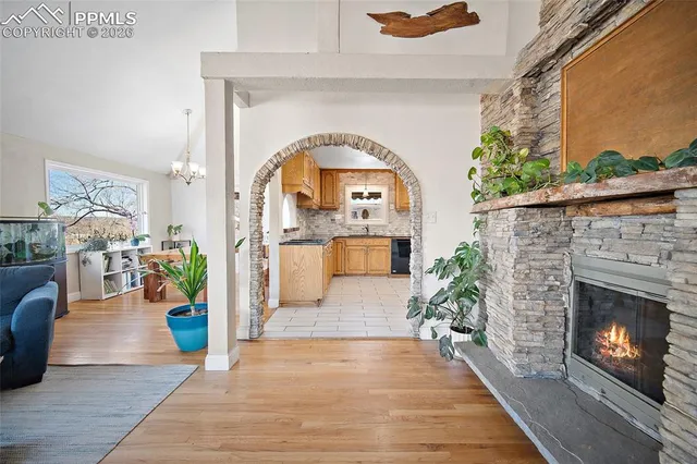 a view of a hallway with wooden floor and a fireplace