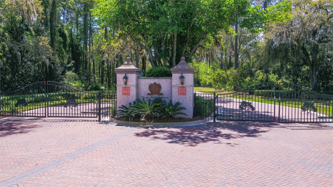 96198 Brady Point Road Fernandina Beach, FL 32034 - Photo 12 of 18 a front view of a house with a yard and table and chairs