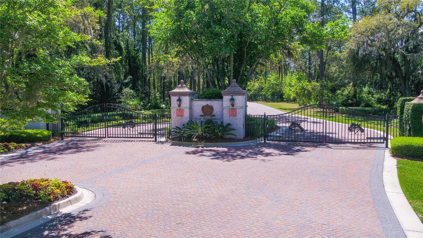 96198 Brady Point Road Fernandina Beach, FL 32034 - Photo 14 of 18 a front view of a house with a yard and a garage