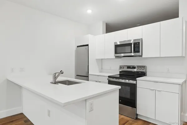 a kitchen with a sink a stove and microwave