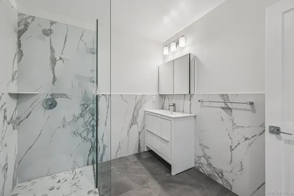 a bathroom with a sink a mirror and shower