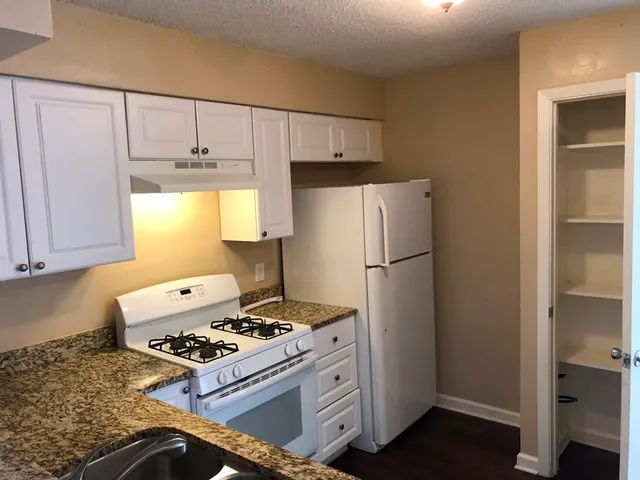a kitchen with a refrigerator stove and sink