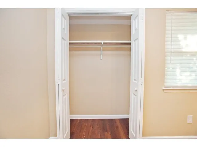 a view of a room with wooden floor
