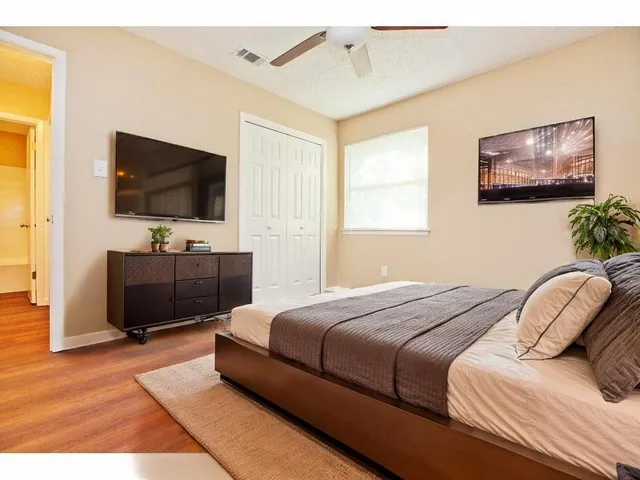 a bedroom with a bed and a flat screen tv