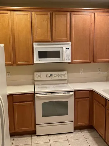 a kitchen with granite countertop cabinets stainless steel appliances and a sink
