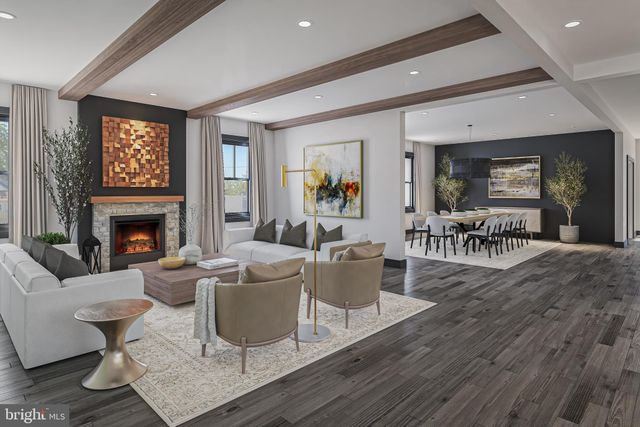 a living room with furniture a fireplace and a table