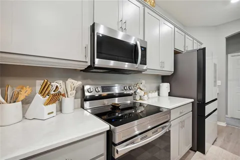 a kitchen with stainless steel appliances a sink a stove and a microwave