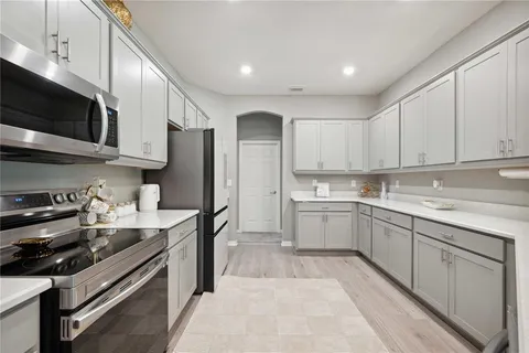 a kitchen with stainless steel appliances granite countertop a stove a sink dishwasher and a refrigerator