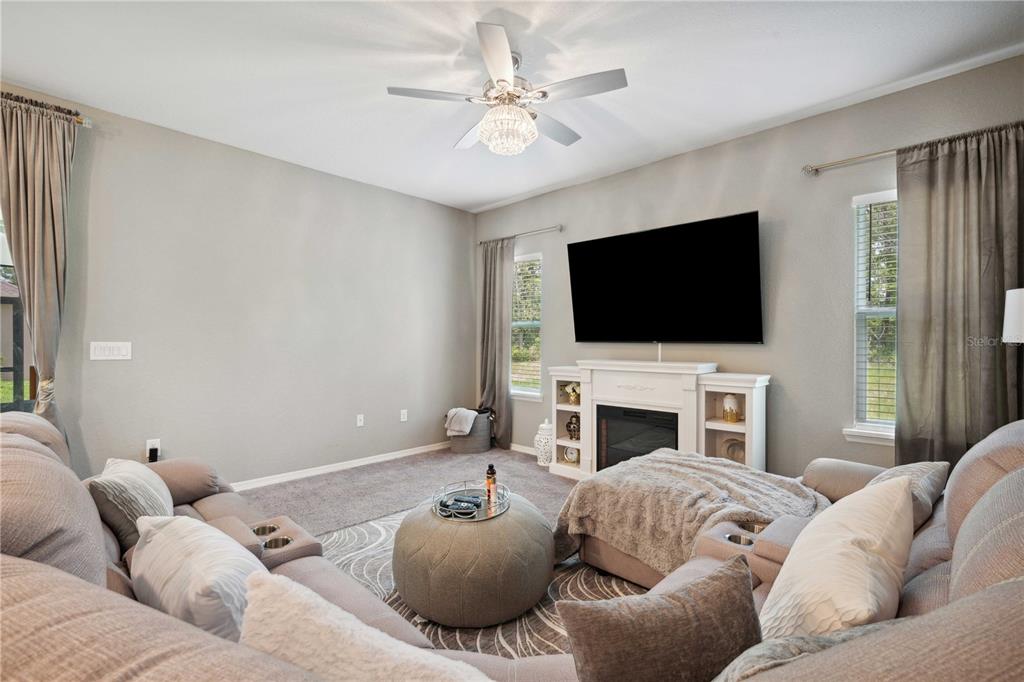5239 Southwest 114th Street Road Ocala, FL 34476 - Photo 15 of 42 a living room with furniture and a flat screen tv